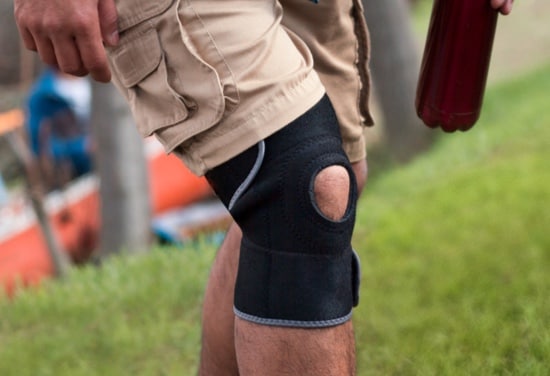 A person walking with a knee brace.