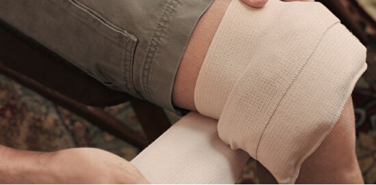 Man with a hot and cold compress on his knee.
